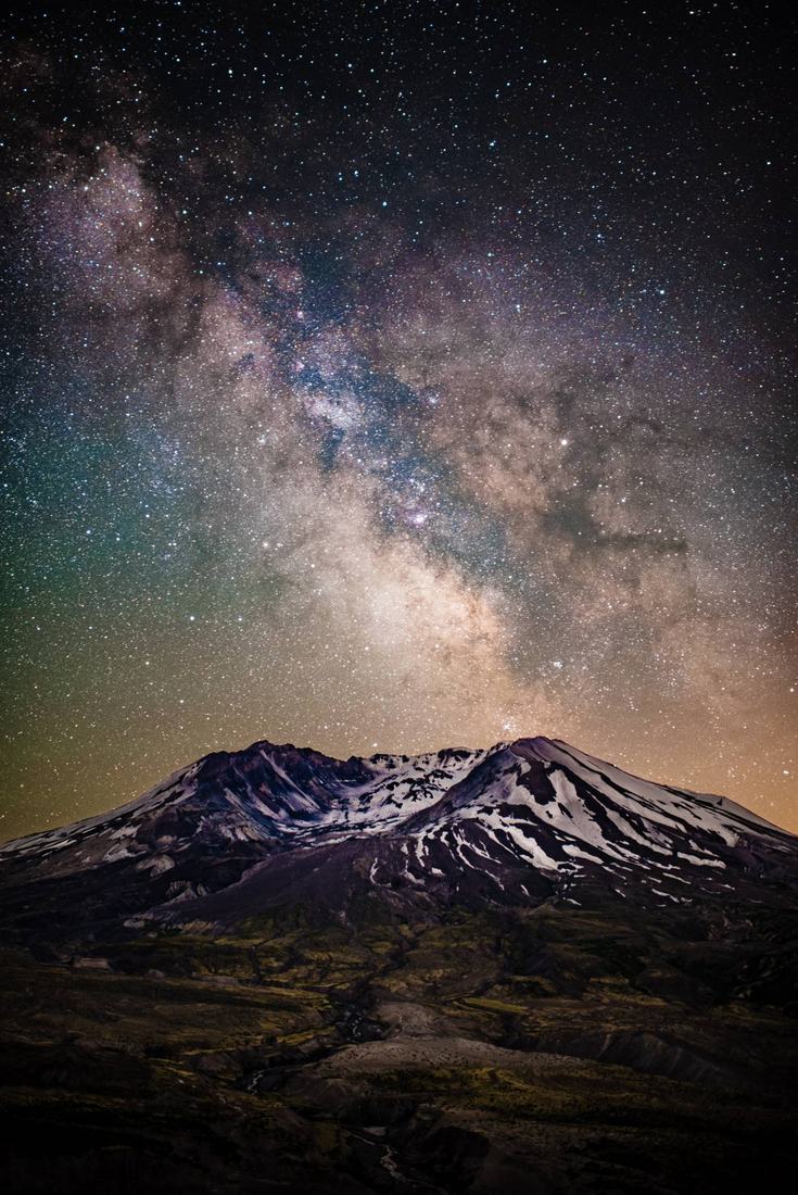 Milky Way rising over a snow-streaked Mount St. Helens at night